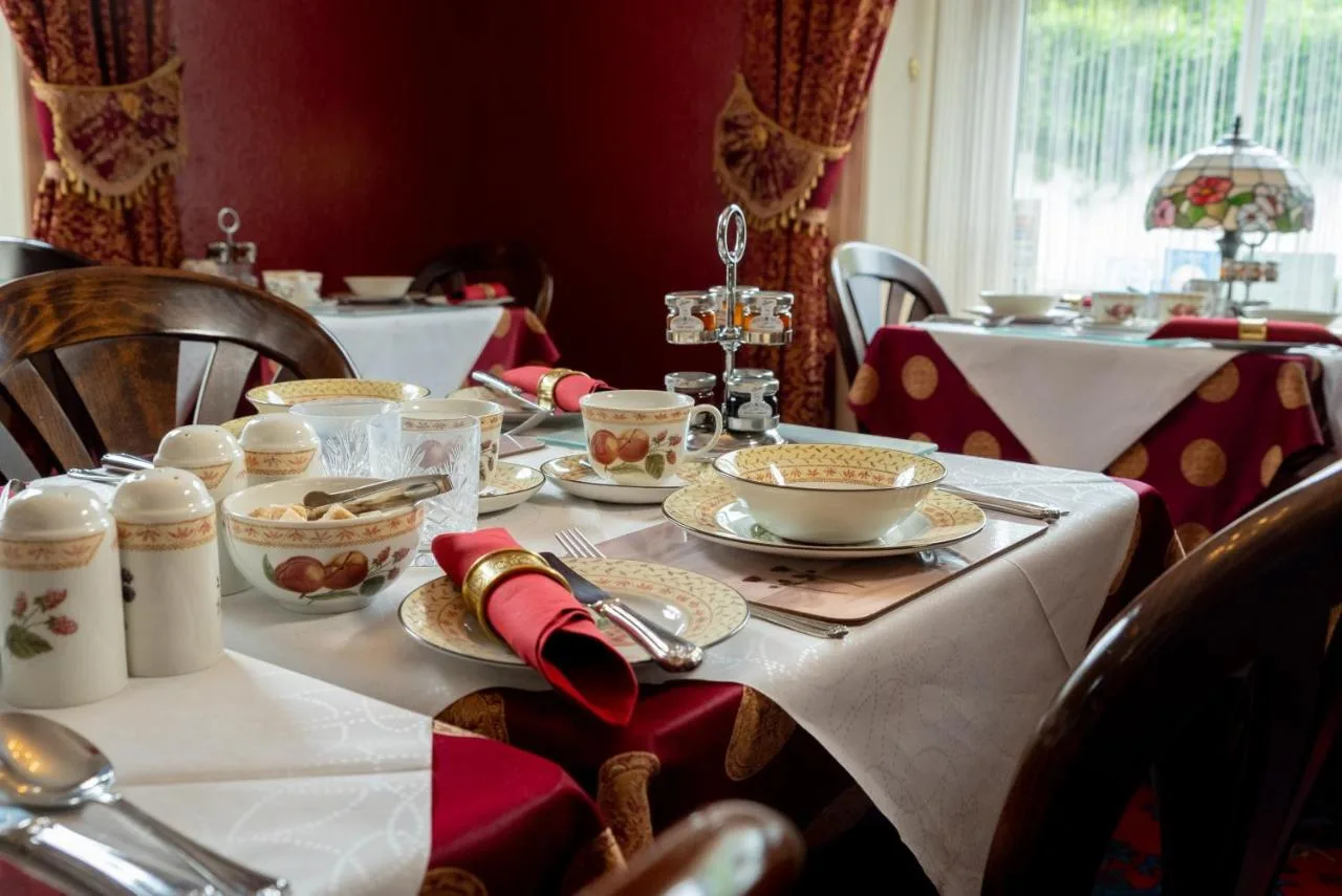 a table with plates and bowls of food on it at Barbican House in York