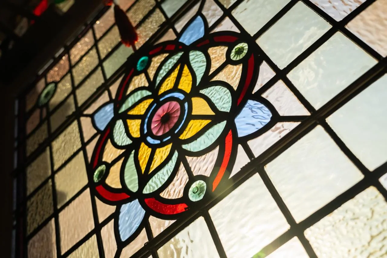 a stained glass window with a flower on it at Barbican House in York